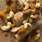Close-up of Jaggery Kaju Badam Papersweet pieces with scattered cashews, almonds and jaggery chunks