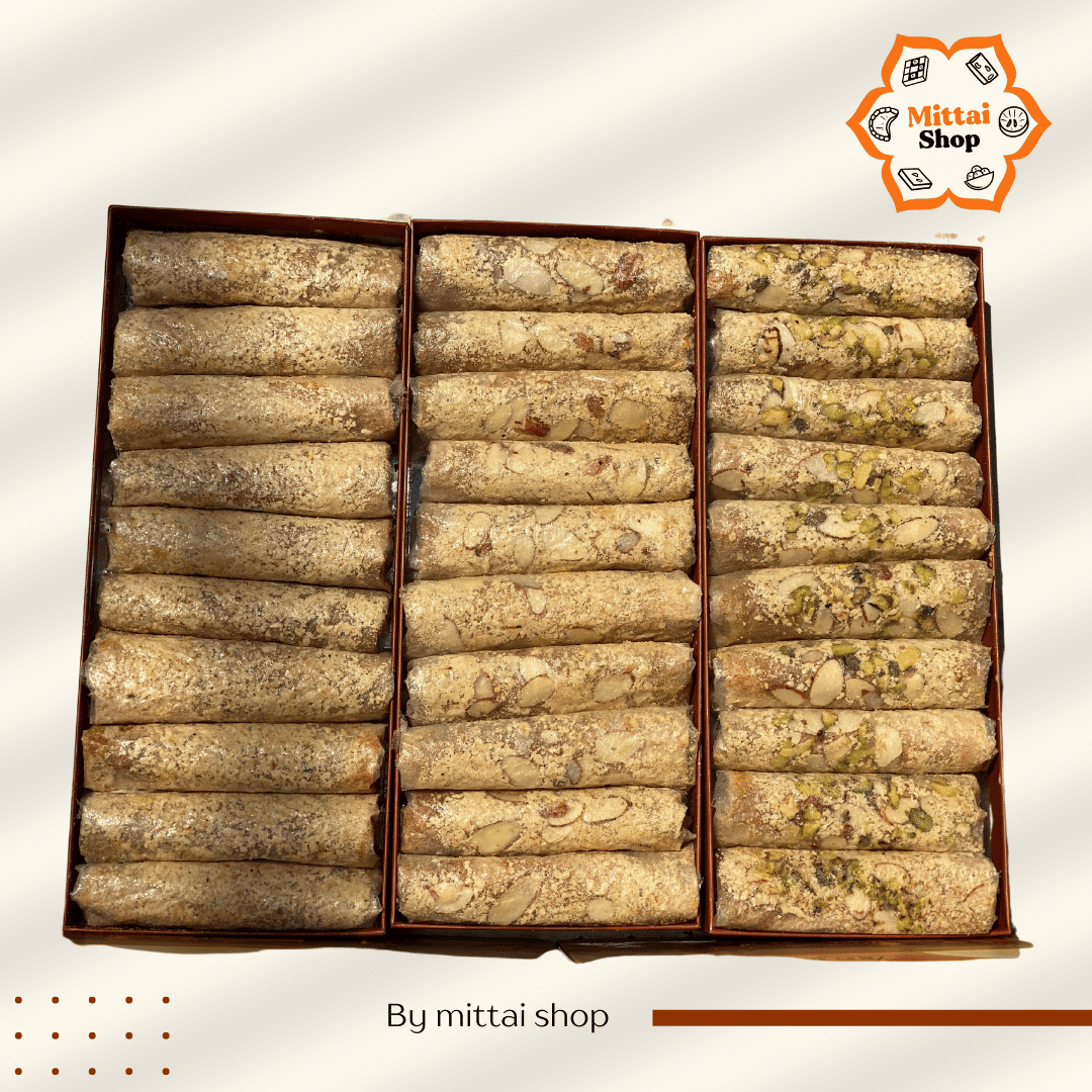 Overhead view of three rows of Jaggery Dry Fruit Papersweet rolls in the Pack of 30 collection, showing Kaju, Kaju Badam, and Kaju Badam Pista varieties side by side