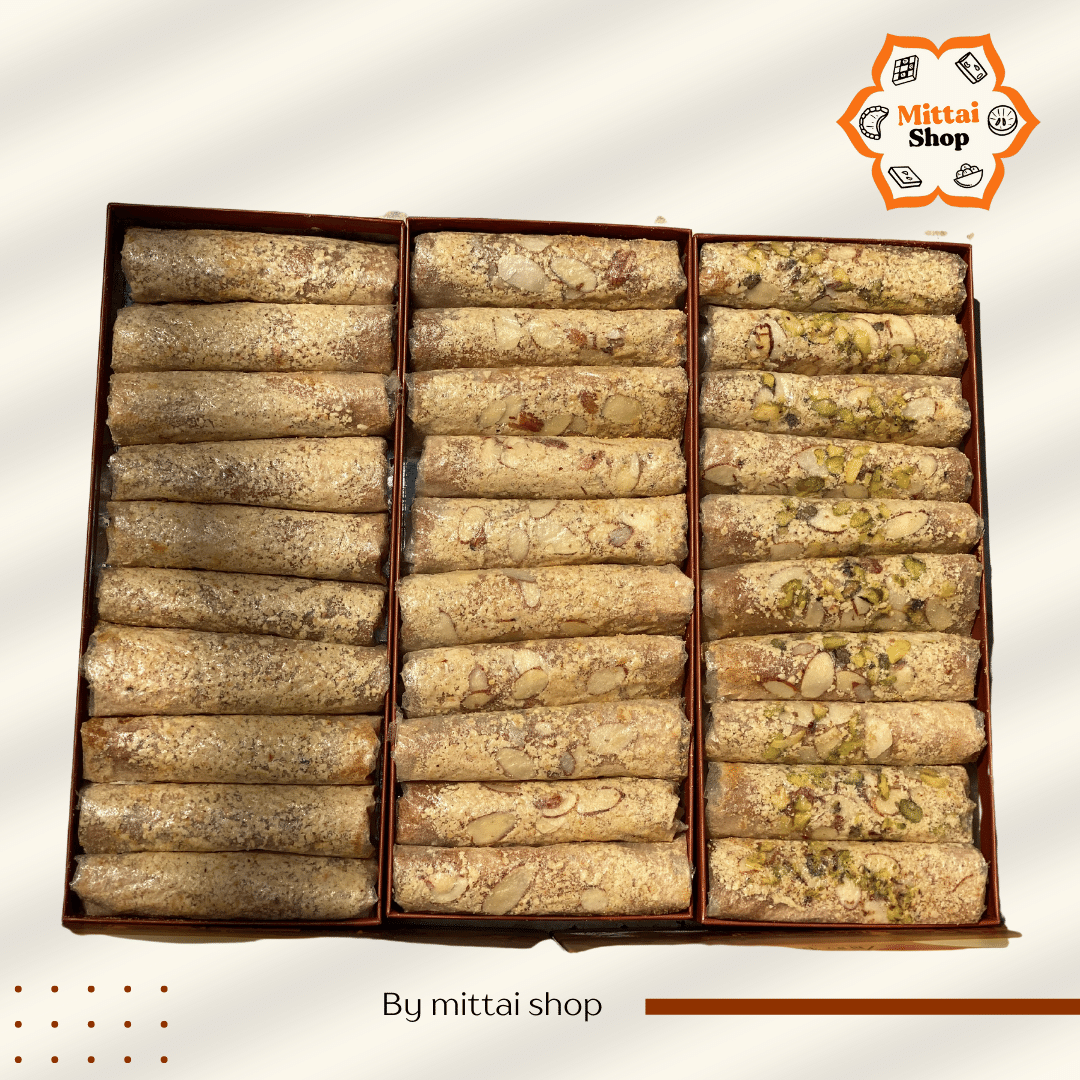 Overhead view of 30 Jaggery Pootharekulu pieces arranged in three rows by variety - Kaju, Kaju Badam, and Kaju Badam Pista