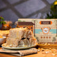 Jaggery Cashew Almond Papersweet rolls topped with almonds on a plate, with the Mittai Shop Atreyapuram Pootharekulu box in the background