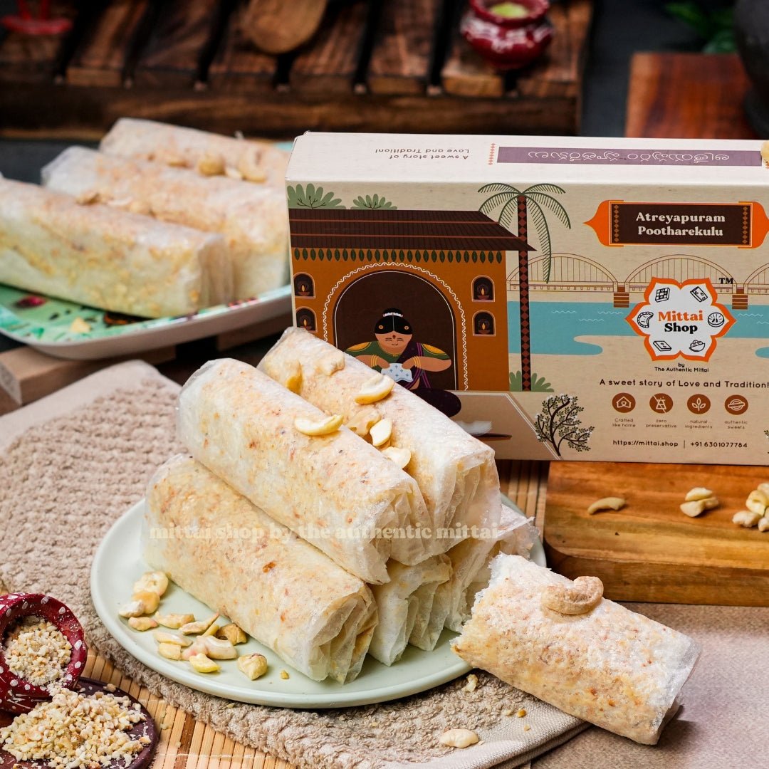 Sugar Kaju Pootharekulu rolls topped with cashews on a plate, with the Mittai Shop Atreyapuram Pootharekulu box in the background